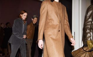 Close up of model's brown long coat