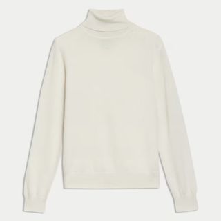 A cutout of a cream M&S polo neck jumper on a white background