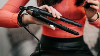 person straightening hair