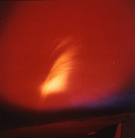 A streak of orange against a red night sky