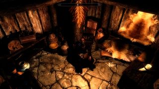 Best Skyrim mods — a Nord rests in a very cozy bedroom.