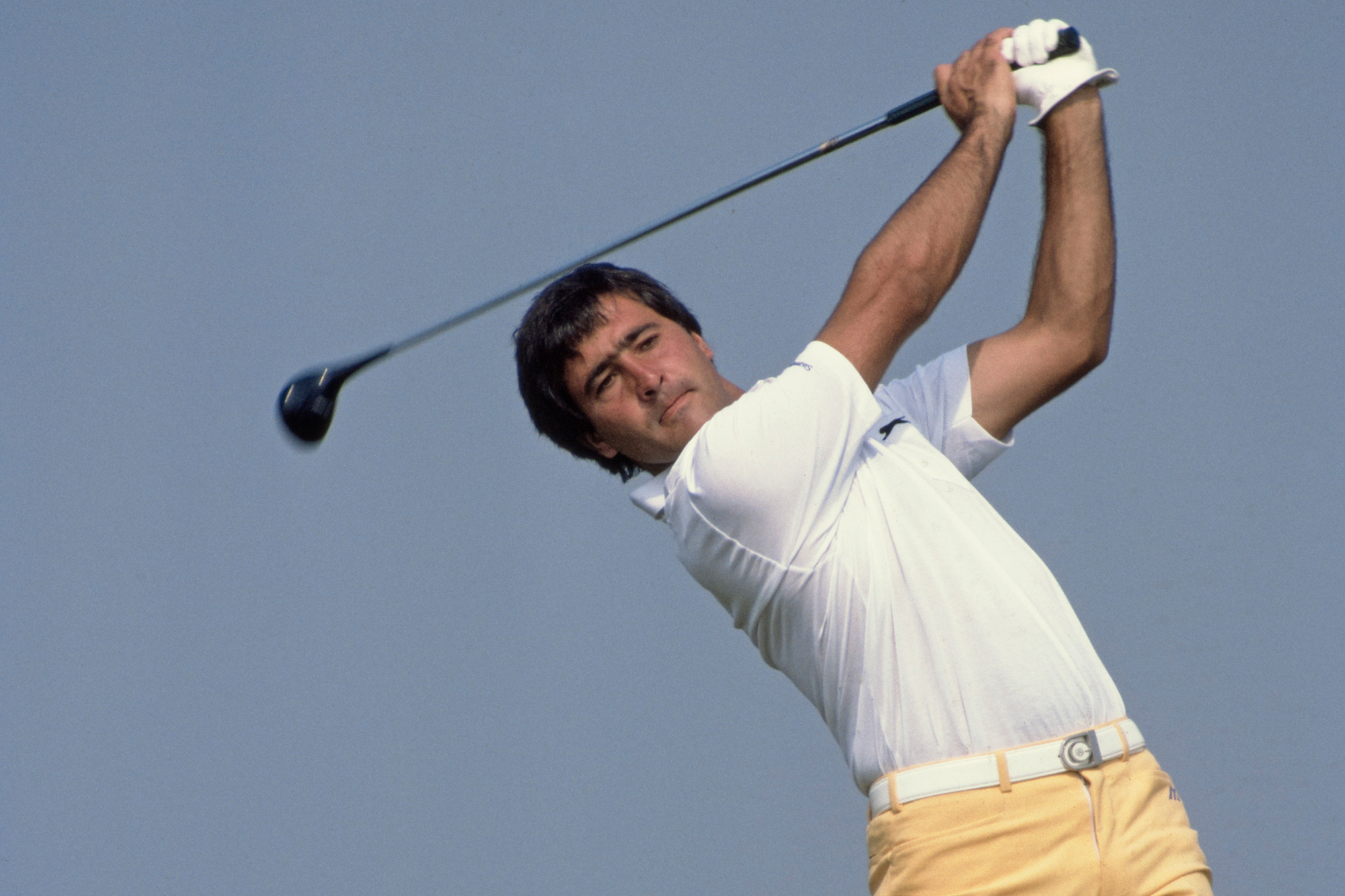 Seve Ballesteros in the high finish position with a wood after hitting a golf shot