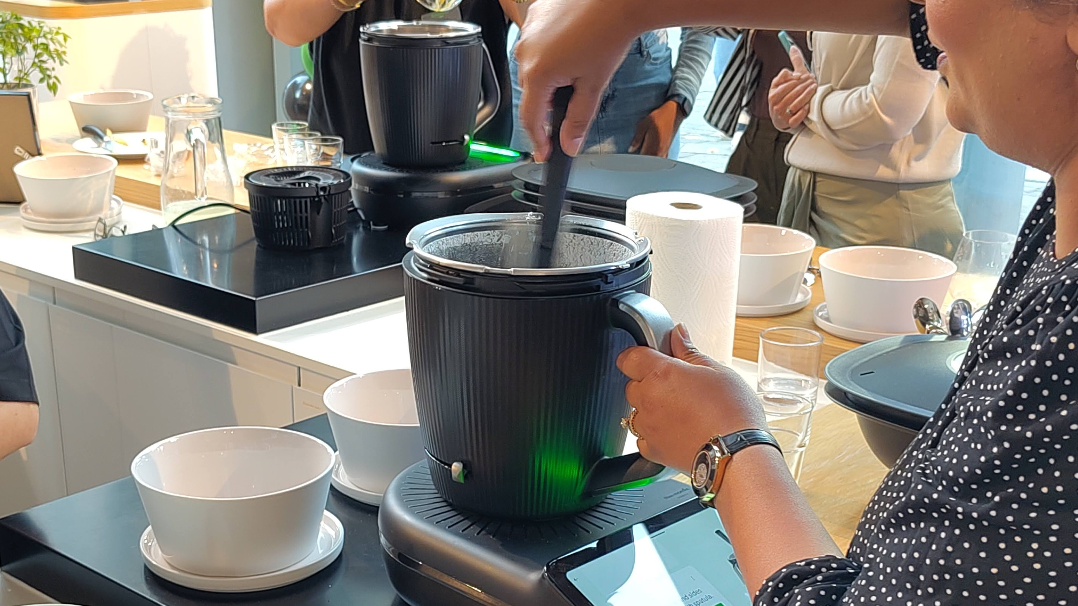 Person scraping inside of Thermomix TM7 using spatula