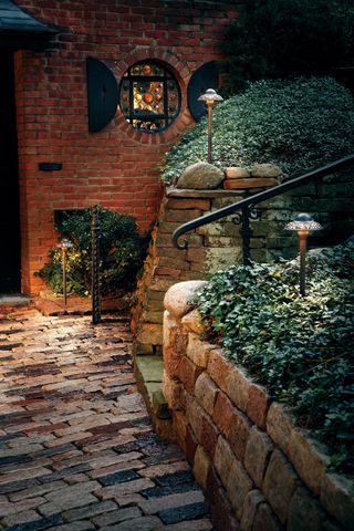 Solar lighting in raised brick wall at front of house