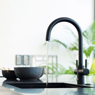 Black boiling water tap in a kitchen