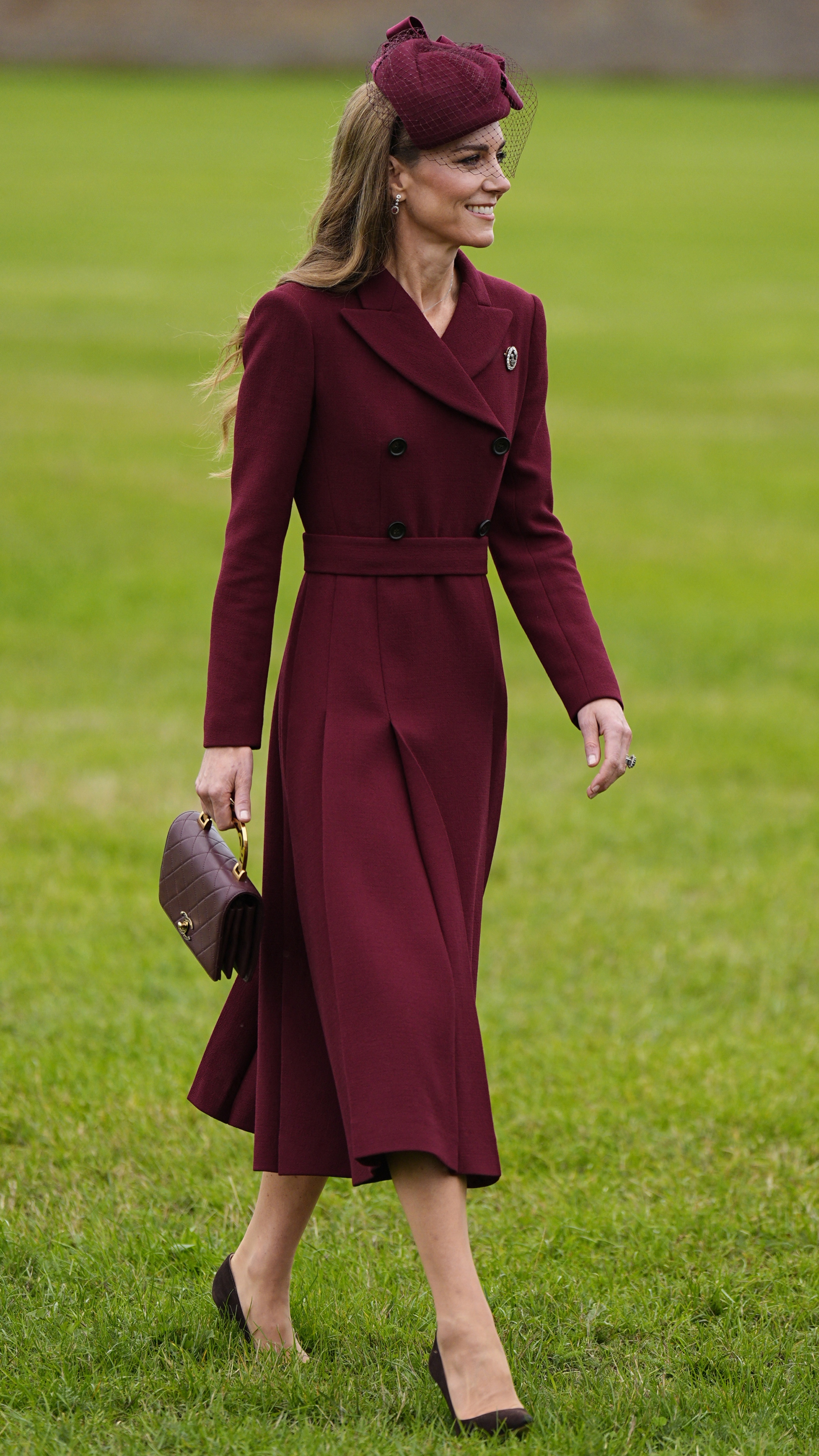 Catherine, Princess of Wales, walks across grass to greet guests on the Windsor Estate, in Windsor, on September 17, 2025