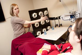 quadriplegic uses mind-controlled prosthetic