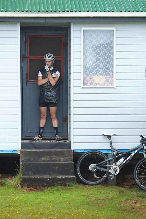 Sid Taberlay gets some Trial Harbour shack time and shelter from the belting rain before riding the Heemskirk stage.