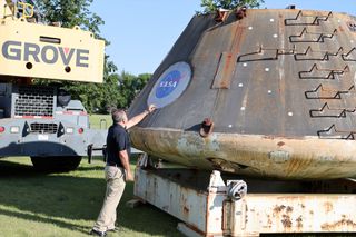 Pablo de León, chair of the space studies department at the University of North Dakota, inspects the NASA logo on the Orion capsule used to test the Max Abort Launch System (MLAS) in 2009.