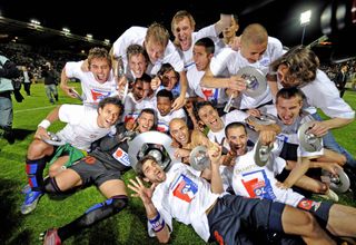 Lyon players celebrate winning their seventh straight Ligue 1 title in May 2008.