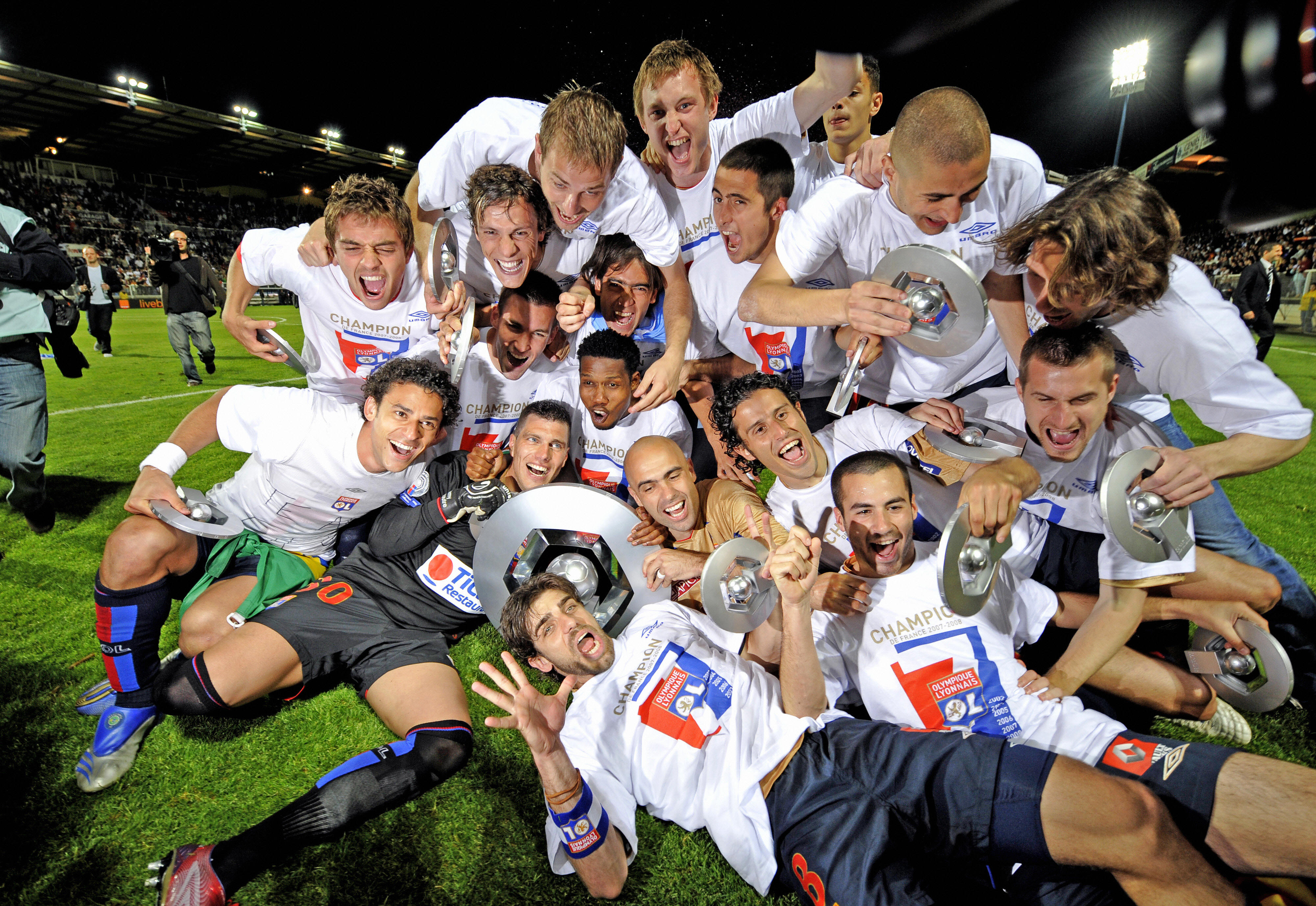 Lyon players celebrate winning their seventh straight Ligue 1 title in May 2008.