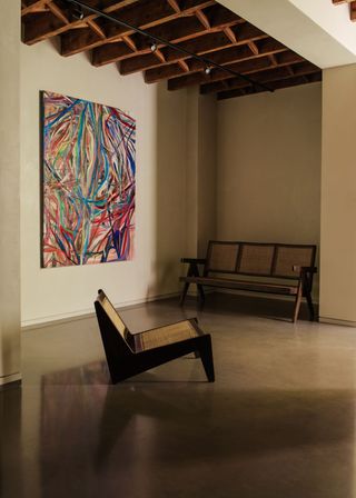 Colorful artwork on the wall and low chair