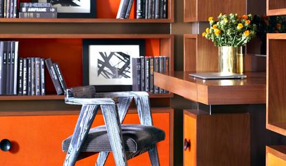 a home office with an orange background
