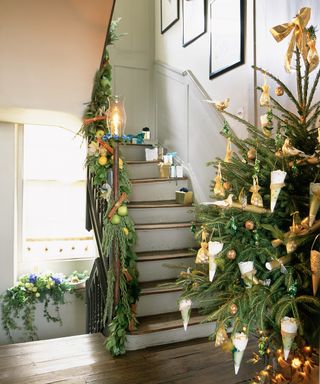 Christmas tree in hallway and stair hand rail with garland