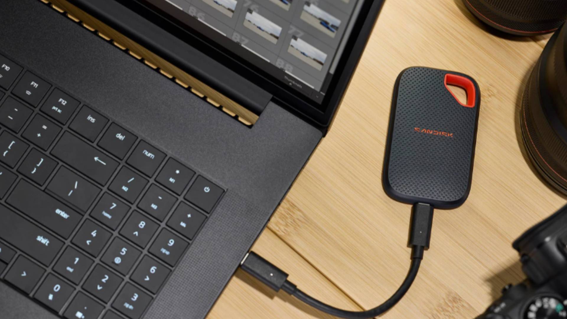 Official image of the SANDISK Extreme Portable SSD hooked up to a laptop.