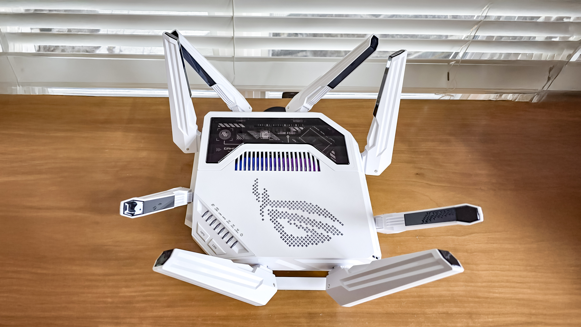 Asus ROG Rapture GT-BE19000AI router on a windowsill