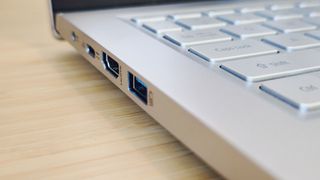 A silver Acer Swift 3 laptop on a light wooden desk