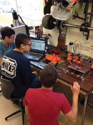 Students print out parts to make another 3D printer.