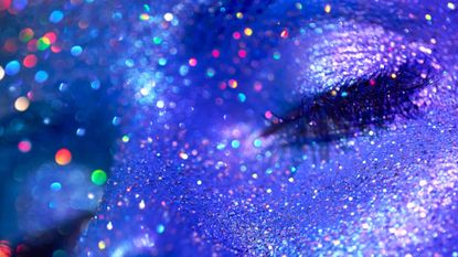 beauty woman with blue glitter on her face