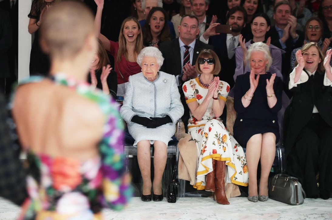 Queen Elizabeth II, Anna Wintour and others watching a London Fashion Week catwalk show