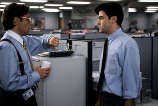(L to R) Gary Cole as Bill Lumbergh checks his watch in front of Ron Livingston as Peter in Office Space