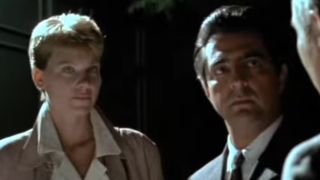 Lindsay Crouse and Joe Mantegna in a night time setting in House of Games