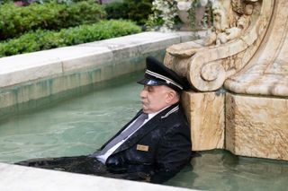 A dead body (Teddy Coluca as Lester) laying in a stone fountain, in 'Only Murders in the Building.'