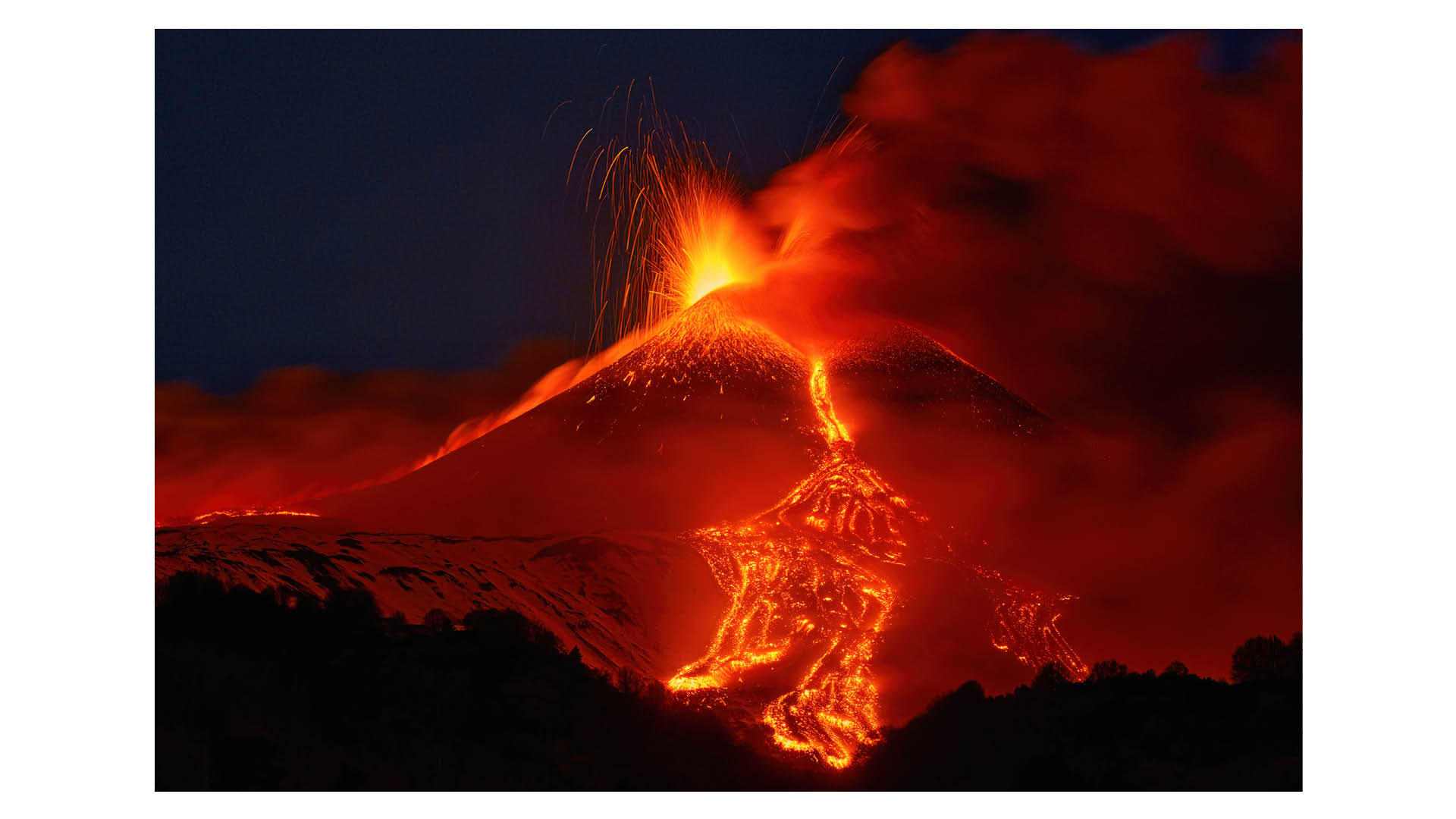 Photograph titled Edna's Paroxysm, taken by Gianluca Gianferrari and the Grand Prize winner of the Hamdan bin Mohammed bin Rashid Al Maktoum International Photography Award (HIPA) 2025. Description reads: Above Sicily's Etna Volcano, glowing lapilli erupt against a snowy backdrop, and thus creating a striking contrast. The fiery bursts settle on fresh snow, forming a kaleidoscope of colors under the night sky. This is a testament to the unpredictable beauty of nature, where destructive power merges with serenity in a fleeting embrace that is eternally captured by the lens of the camera. 