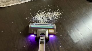 The Shark Cordless PowerDetect picking up rice and oats on hard floor