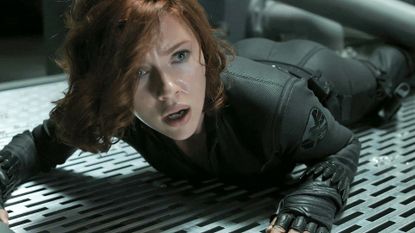 Black Widow lying on the floor and looking shocked in a Marvel movie