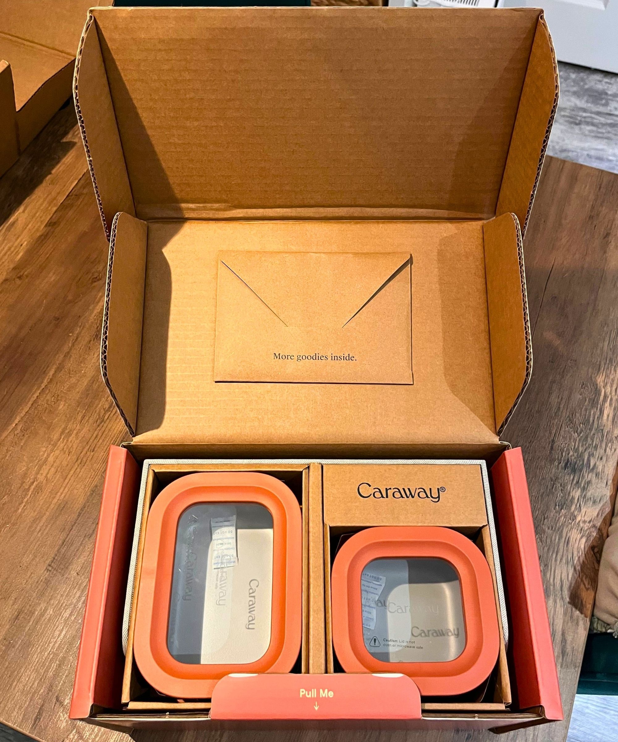 Caraway non toxic food container set as it's packaged for delivery. It's all cardboard and no plastic, and carefully packed, making it feel like a premium buy or gift