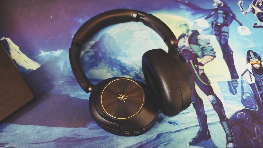 A pair of black OneOdio Focus A6 headphones on a gaming desk mat