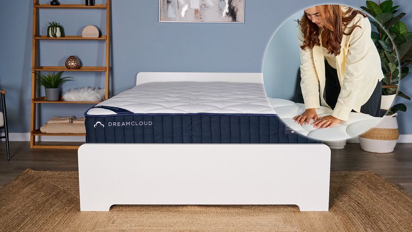 The main image shows the DreamCloud Classic Hybrid Mattress on a bed frame in a bedroom. In the left corner is an ident showing mattress tester Eve Davies pressing her hands into the quilted cover of the DreamCloud