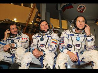 Expedition 34 Flight Engineer Chris Hadfield of the Canadian Space Agency (left), Soyuz Commander Roman Romanenko (center) and NASA Flight Engineer Tom Marshburn (right) are scheduled to launch Dec. 19 from the Baikonur Cosmodrome in Kazakhstan on the Soyuz TMA-07M spacecraft.
