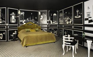 Hotel room with green bedding and black and white picture walls