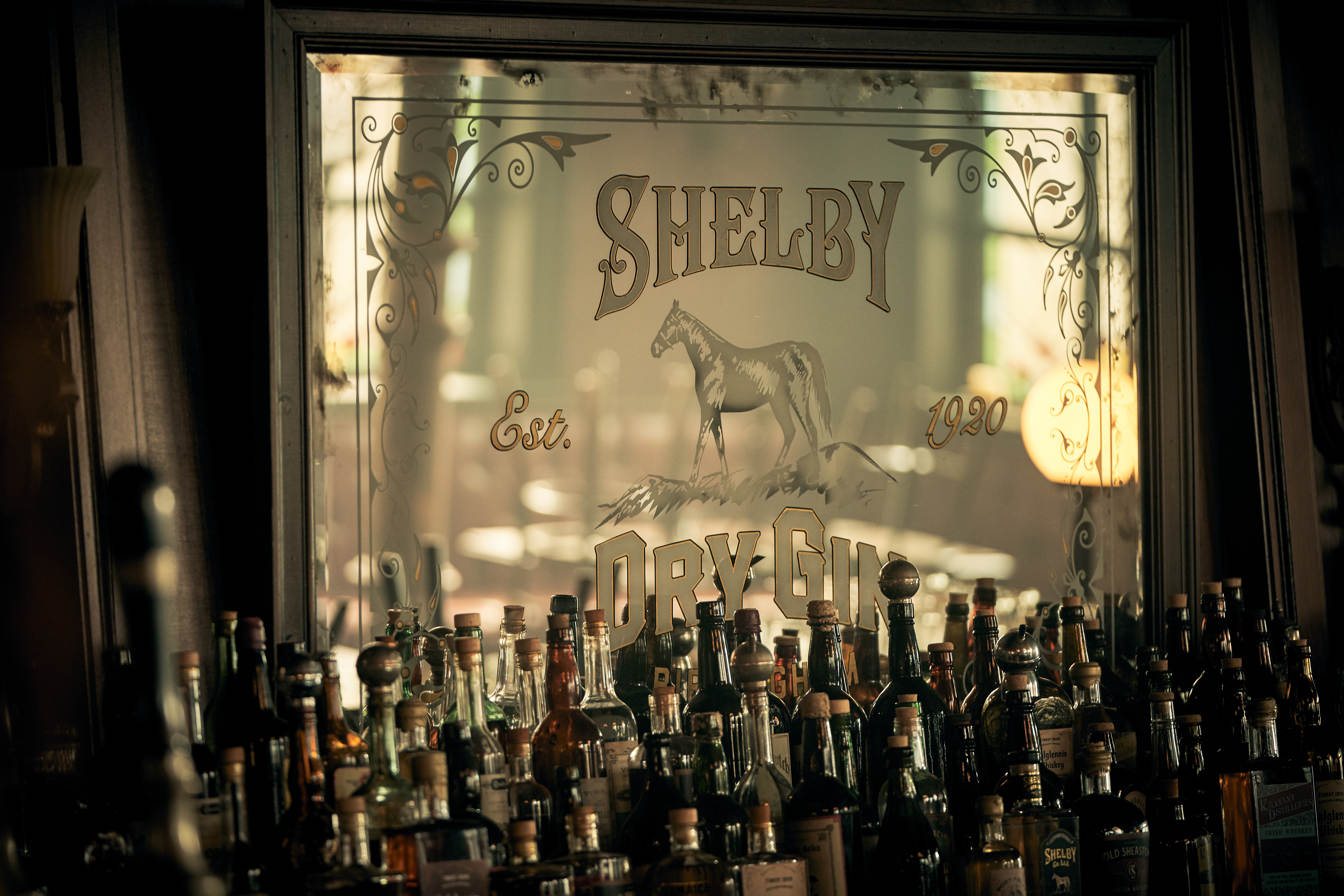 Mirror with Gin bottles in front of it