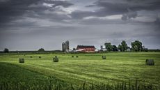 A farm with a red barn and silos in rural Wisconsin.