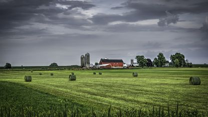 A farm with a red barn and silos in rural Wisconsin.
