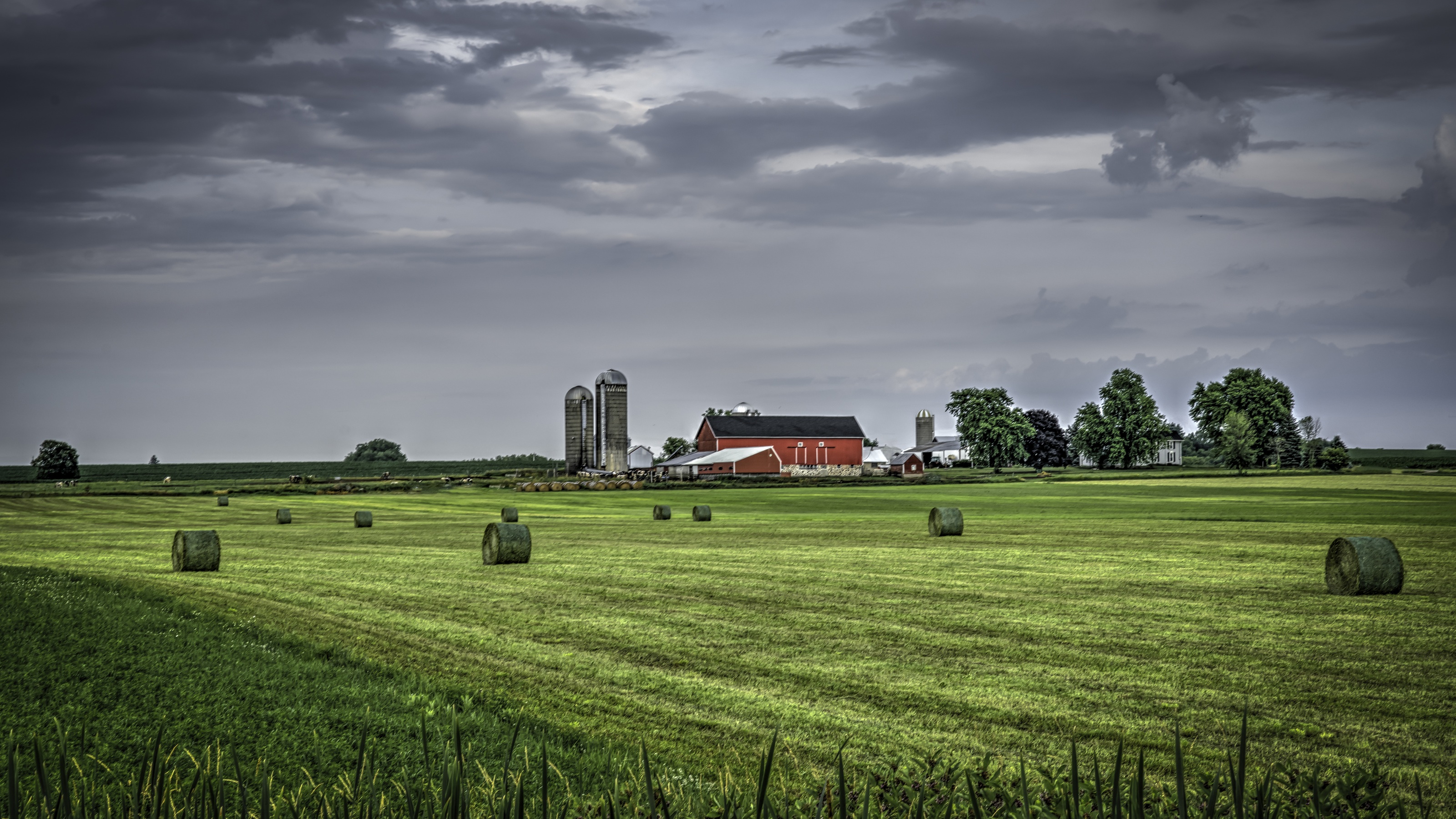 A farm with a red barn and silos in rural Wisconsin.