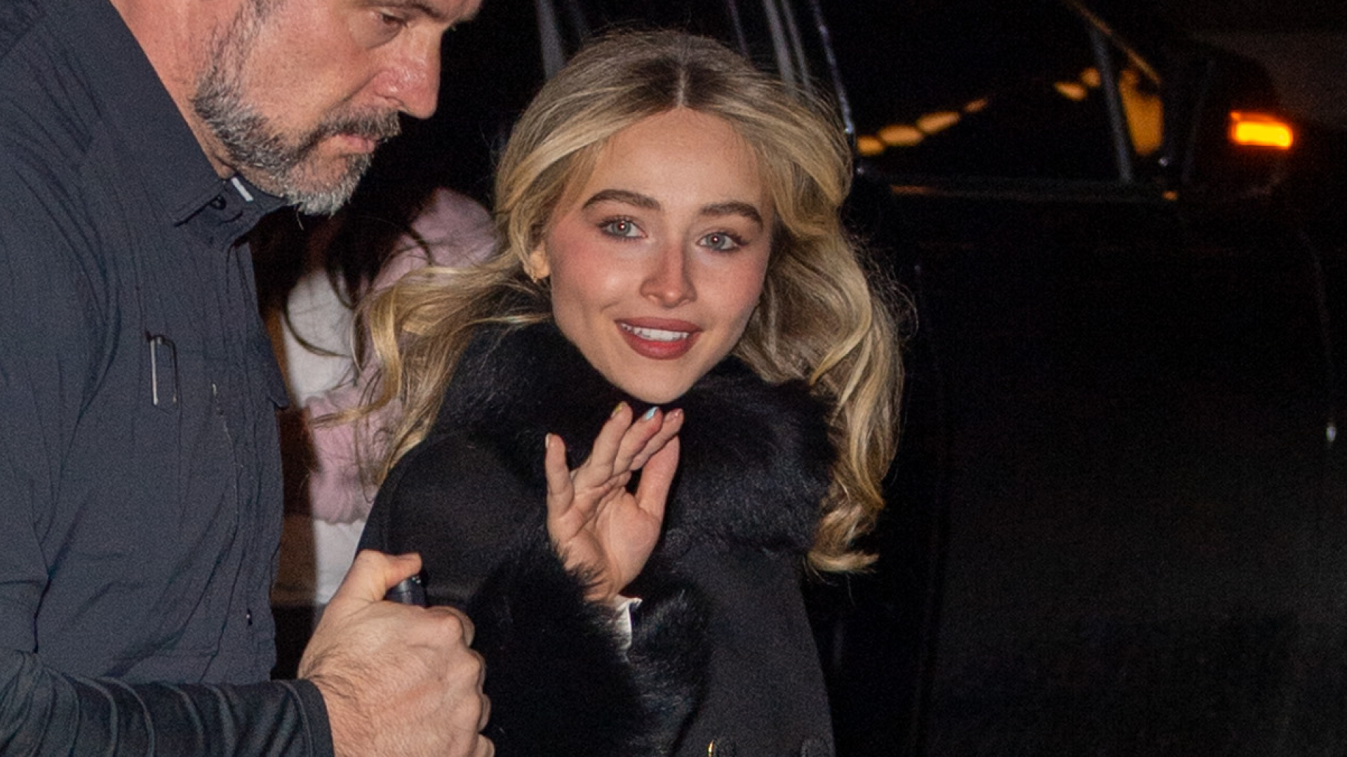  Sabrina Carpenter is seen on January 17, 2026 in New York City wearing a black fur-trimmed coat, a silky slip dress, and platform Christian Louboutin heels