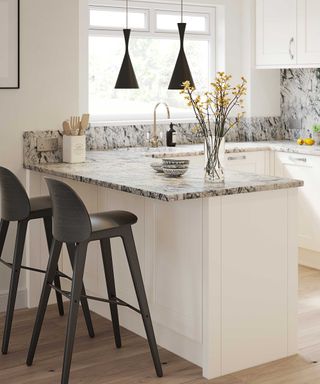 small kitchen with peninsula with marble worktops