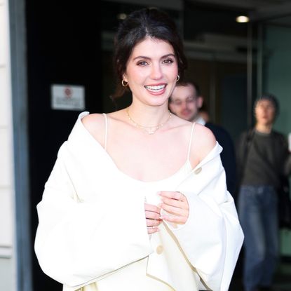 Emily Bader wore a butter yellow satin slip dress on the People We Meet On Vacation press tour