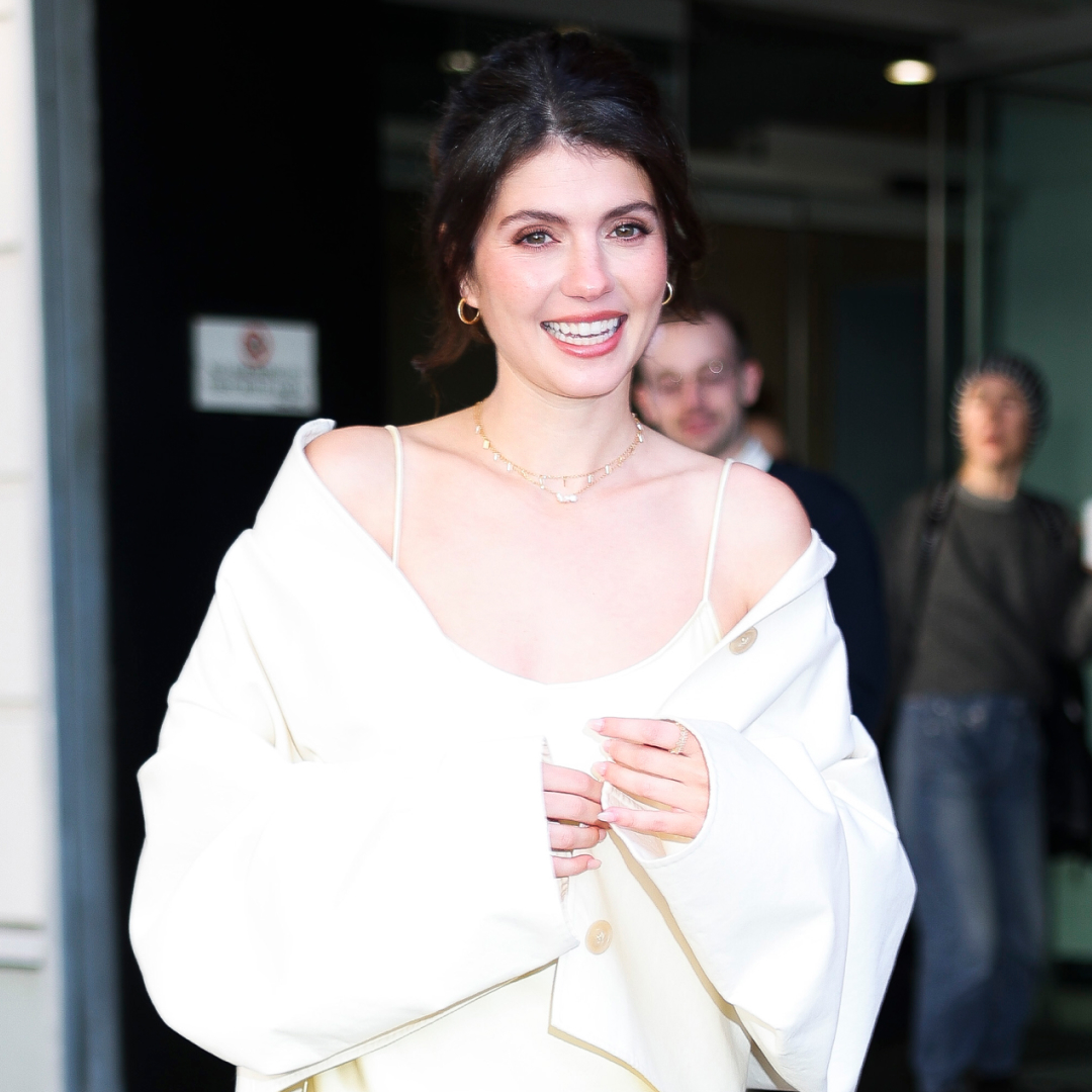 Emily Bader wore a butter yellow satin slip dress on the People We Meet On Vacation press tour