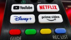 A close-up of a television remote showing various streaming options.