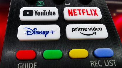 A close-up of a television remote showing various streaming options.