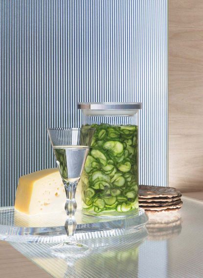 Glass of water, picked cucumber, crackers and cheese: example of gut health foods