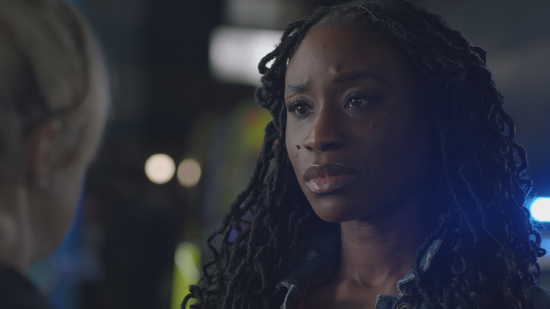 Ngozi after her shift outside as night falls with Nicole and looking grave.