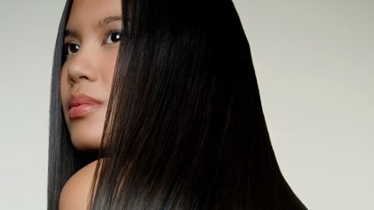 a woman with smooth keratin treated hair looking into the distance