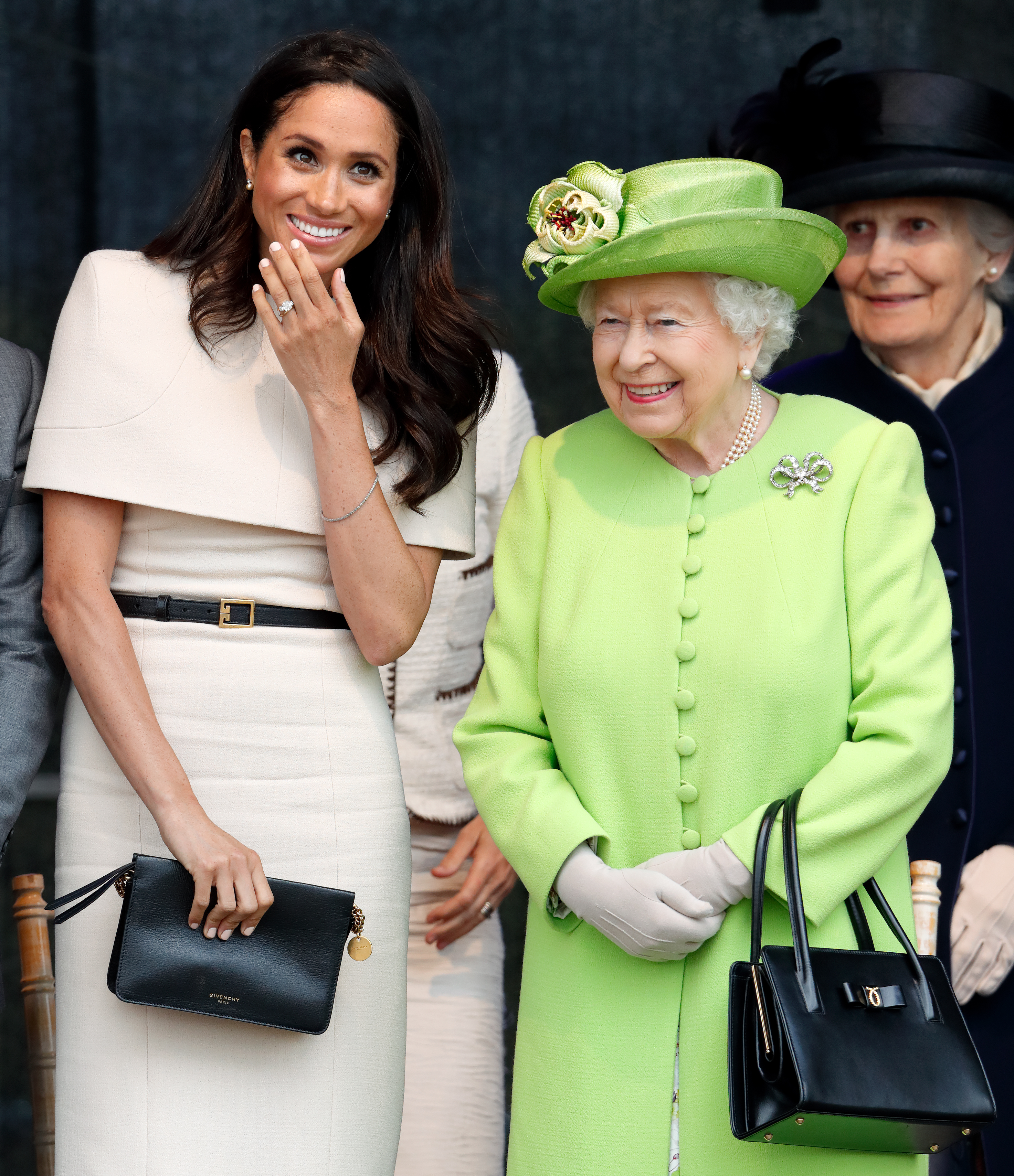 Meghan Markle wears a cream dress and attends a joint engagement with Queen Elizabeth, who wears a bright green coat, on June 14, 2018