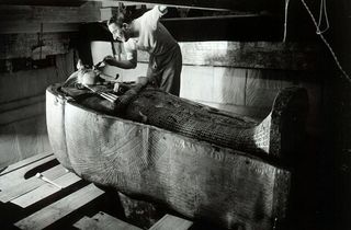 Man cleaning sarcophagus